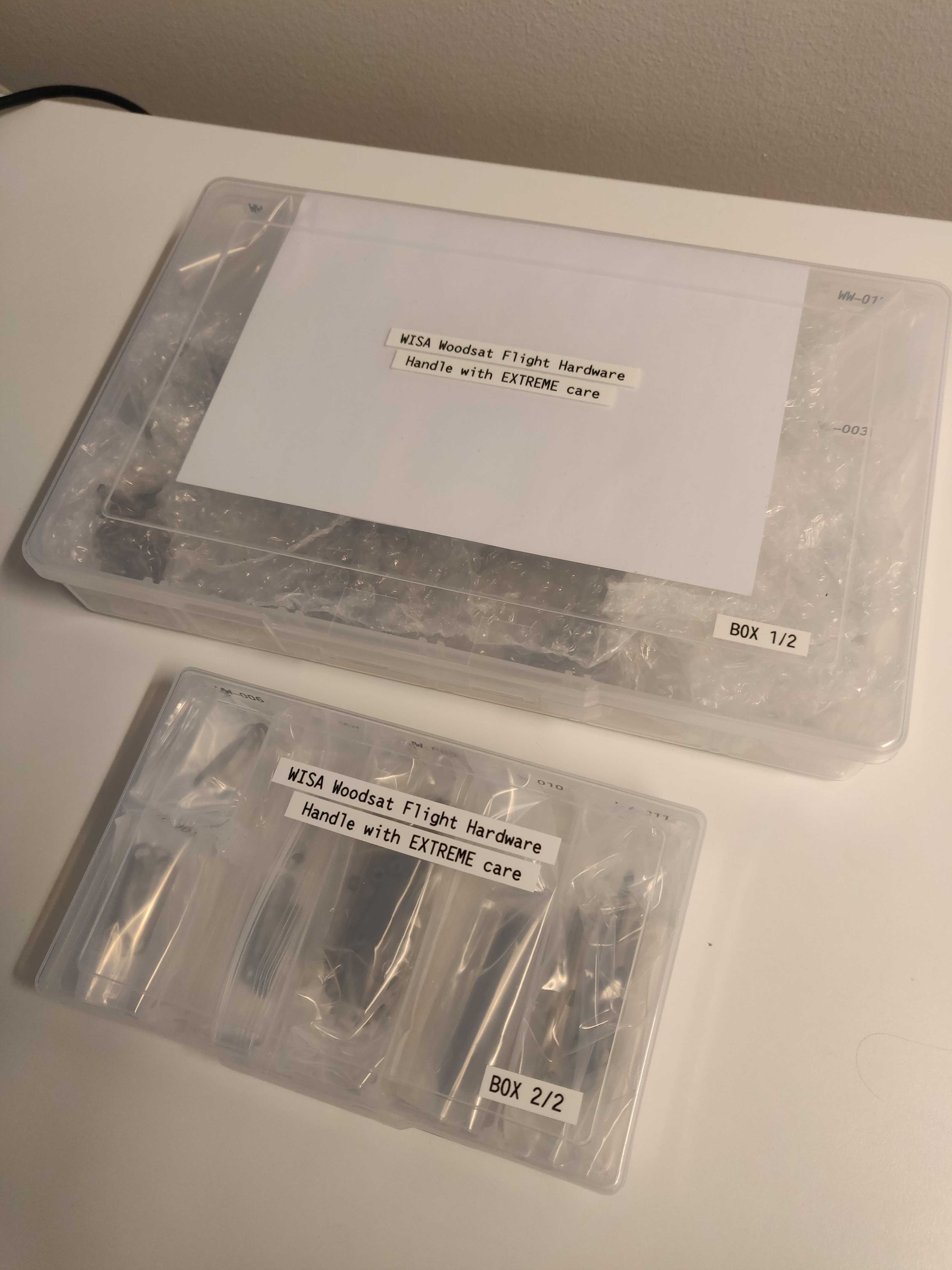 Parts of the satellite and backup model are waiting eagerly for the assembly.